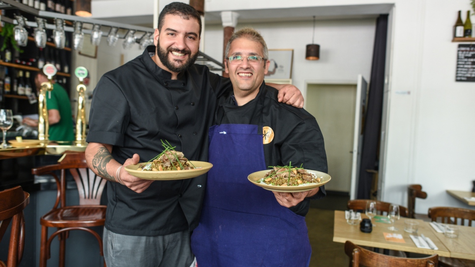 Syrian refugee chef Nabil Attar and French chef Walid Sahed show their joint creation at Les Pantins restaurant in Paris on June 16, 2017.

 