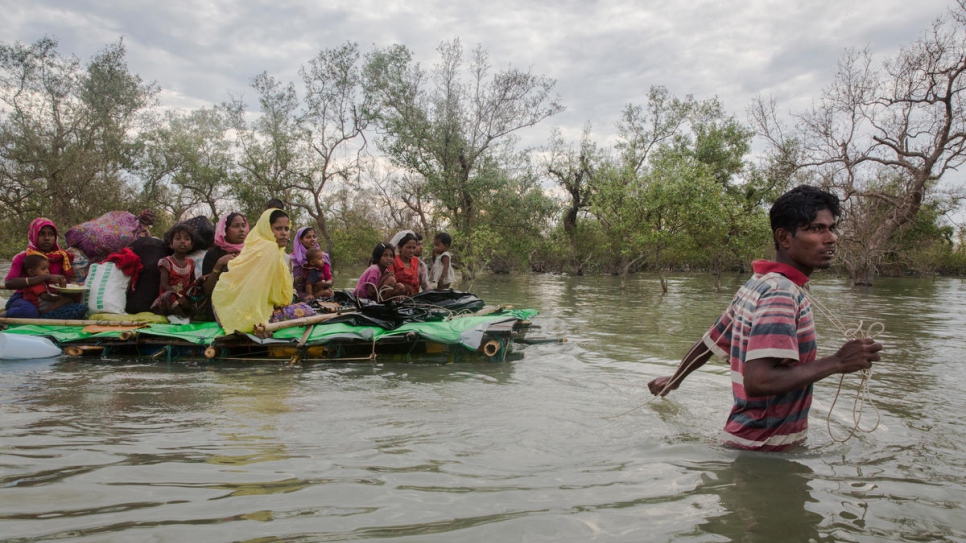 Rohingya refugees cross from Myanmar into Bangladesh on makeshift rafts.