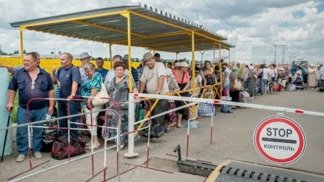Ukraine. Families wait to pass through a checkpoint in Marinka, close to the conflict zone