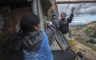 Diana, an internally displaced person, attends to a shelter at Altos de la Florida, Colombia.