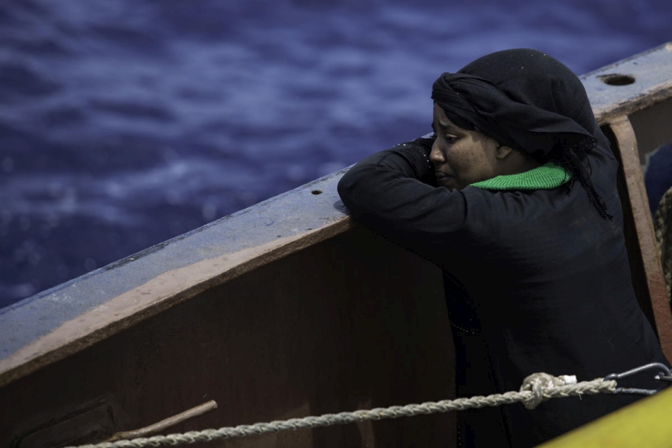 A woman weeps, minutes after being saved by the Sea Watch search and rescue ship.