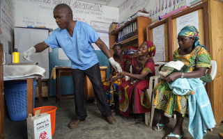 A Congolese woman has blood drawn from her finger by Dr. Kalibongo Raymond during an STD screening at the health center in Kitsule, North Kivu, Democratic Republic of Congo.