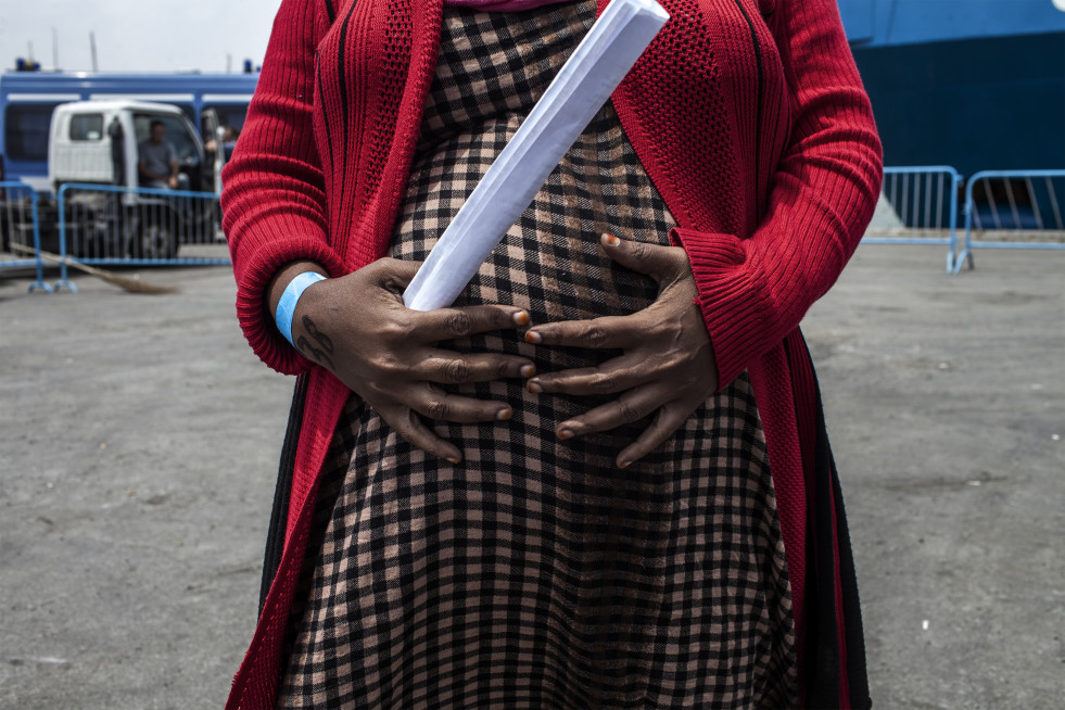 Jamila resting on the docks at Catania's port, Sicily, having been rescued at sea by the Swedish coast guard. She is seven months pregnant. Jamila doesn't know where her baby will be born.