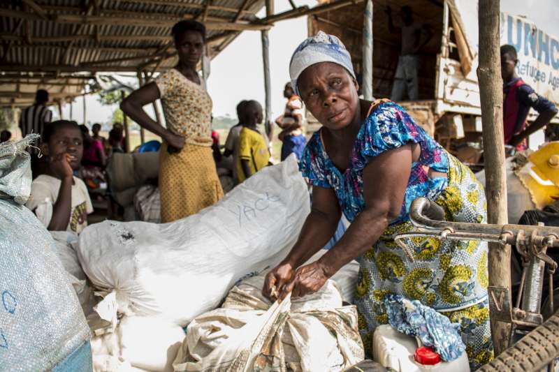 An Ivorian refugee woman in Liberia prepares her luggage ahead of repatriation.