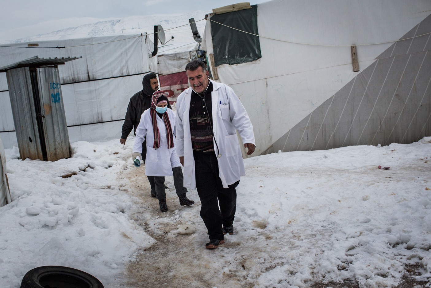 Dr Zeineddine Saad and midwife Omaya Khatib make their way through the snow to check up on the triplets.