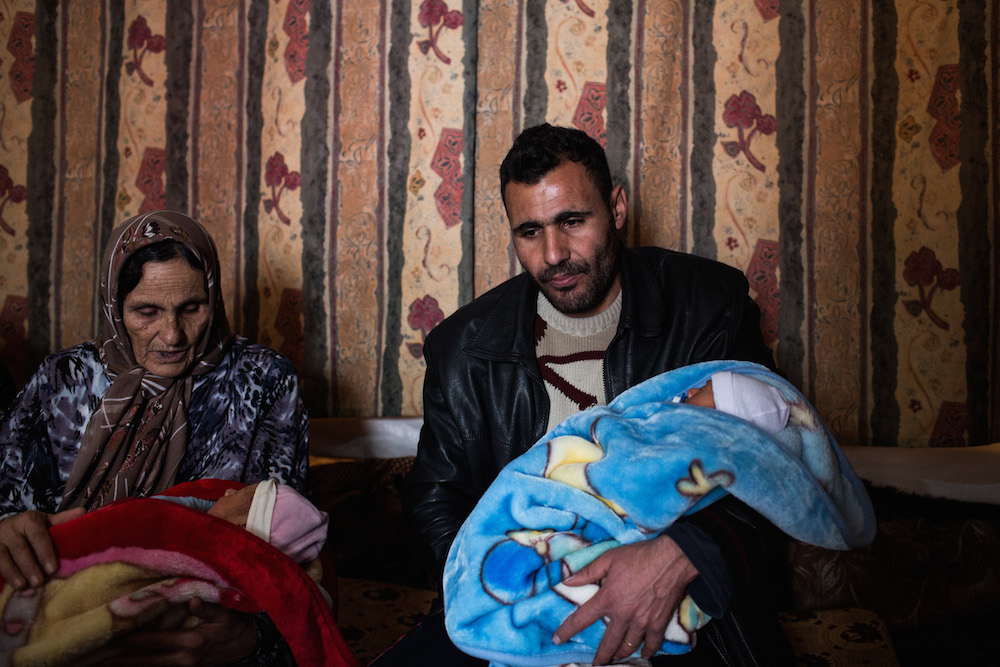 Saleh and his mother hold two of the triplets at the family’s shelter in Bekaa Valley, Lebanon. His wife, Amal, experienced heavy bleeding and died soon after giving birth.