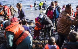 A refugee from Syria hugs her crying daughter moments after reaching the Greek Island of Lesvos from Turkey in an inflatable boat.