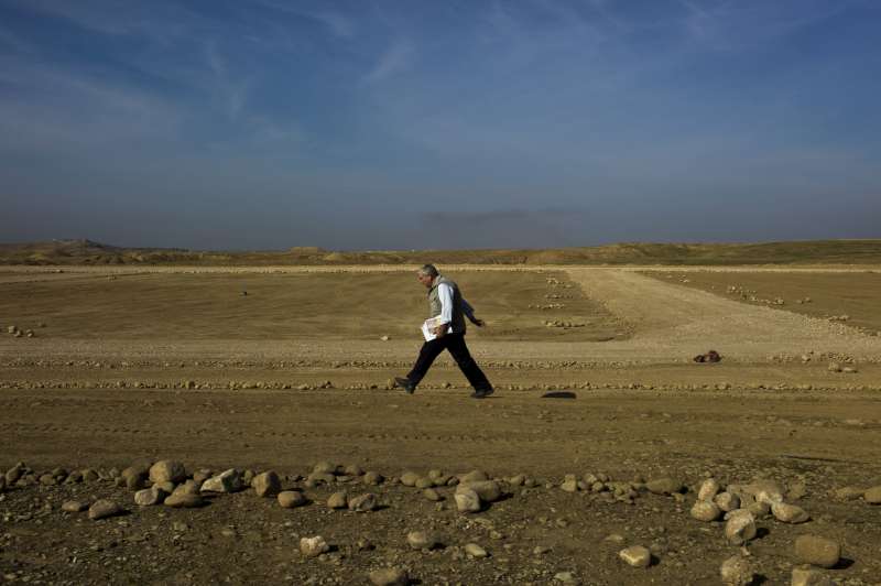 UNHCR's Chris Nixon walks a camp perimeter, his strides measuring the size of the camp, which UNHCR is building in northern Iraq to house some 2,500 Iraqis displaced by conflict.