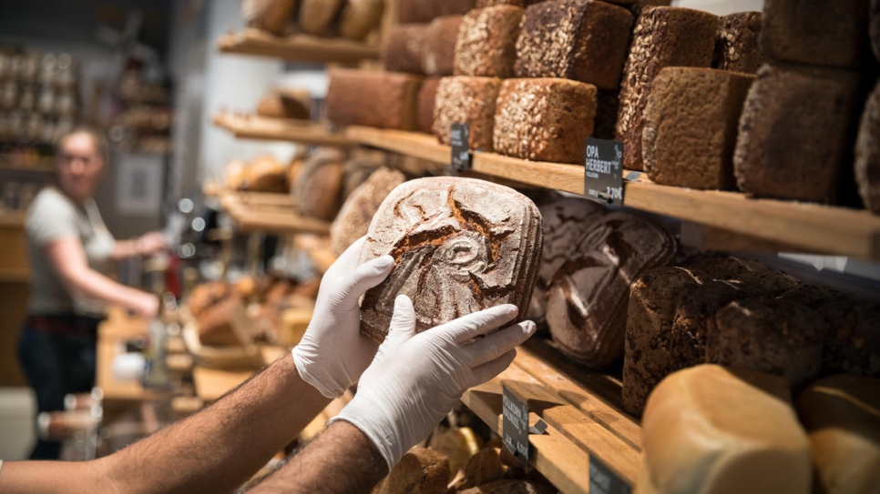 Loaves of bread line the shelves at the bakery where Mohamad works.