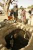 A Sudanese refugee hoists a jerry can of water out of a well in Birak, Chad. The locals generously share their dwindling water supplies with thousands of newly arrived refugees from the Darfur region.