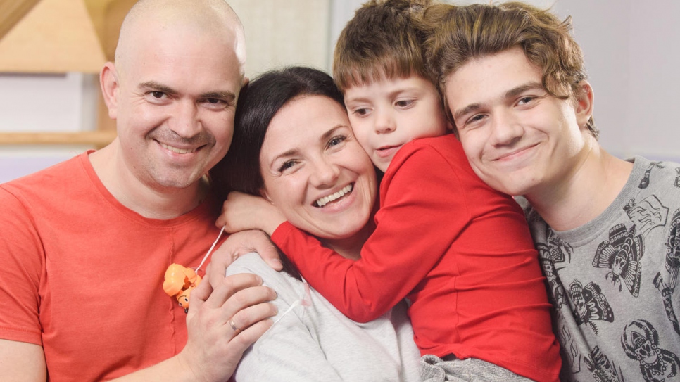 Olena and her family at the centre, which opened in Sumy with the help of UNHCR.