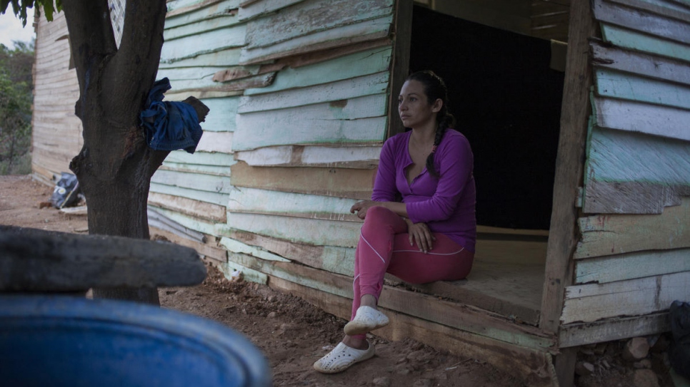 Jenire Rojas, 30, from Venezuela, sits outside Graciela Sanchez's home in Las Delicias, Cúcuta, Colombia. 