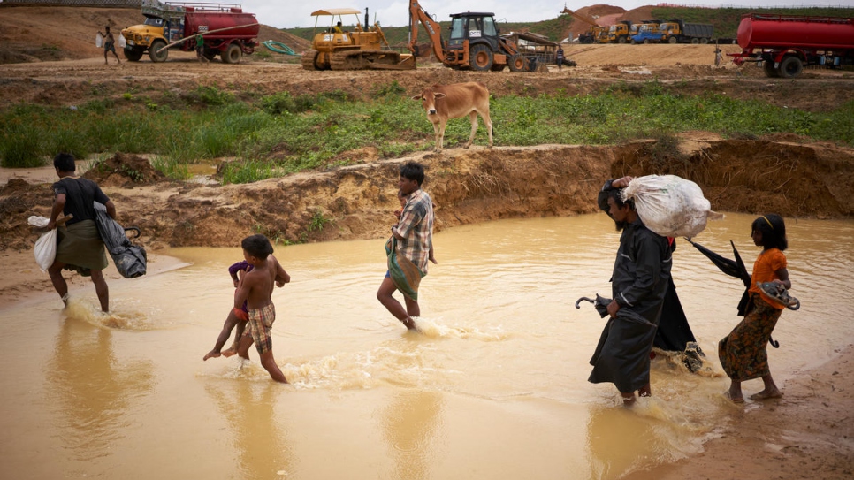 Rohingya refugees are relocated from flooded areas to new shelters in Cox's Bazar.