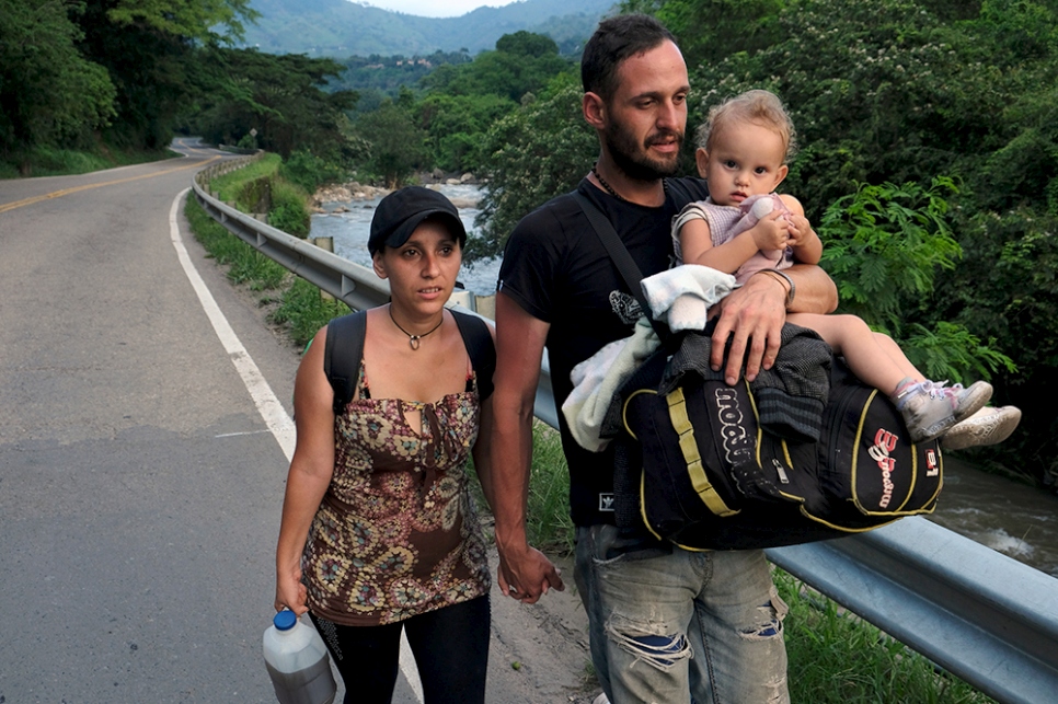 Luis and Magaly, a Venezuelan couple from Mérida, carry their daughter Izabella along a highway from the border city of Cúcuta. They are heading 450 kilometres south-west to the city of Tunja in the department of Boyacá, Colombia, where Luis has a job lined up in a mechanical workshop.