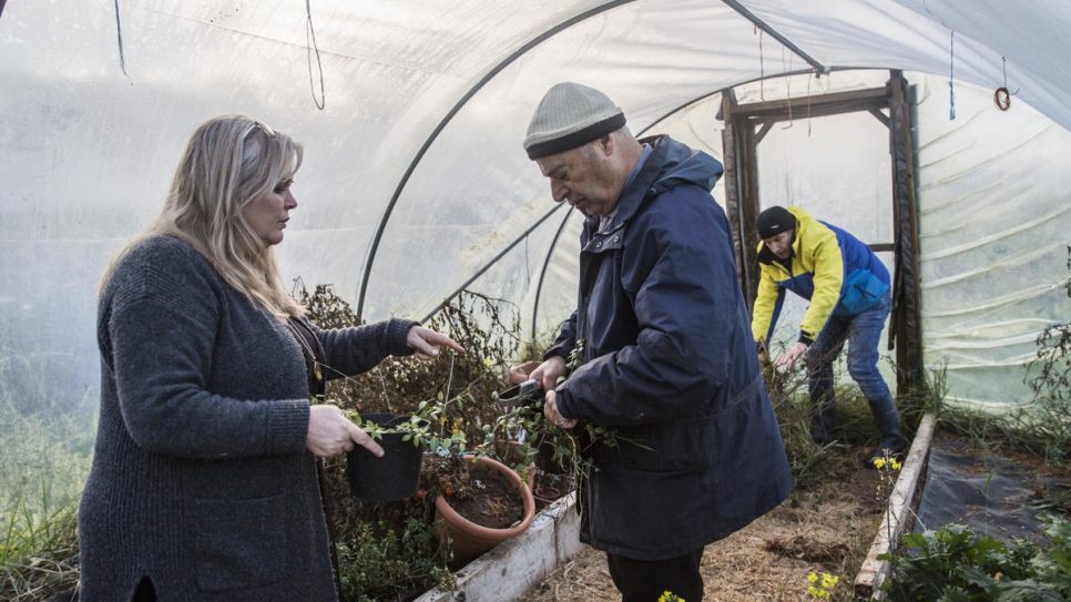 Anna, Faisal and Abdulhadi tend to the gardens and plants that grow in a polytunnel.