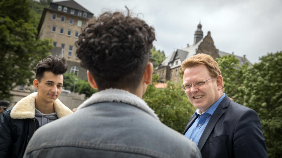 Mayor Andreas Hollstein chats to 17-year-old refugees Hani (left) and Mohamad.