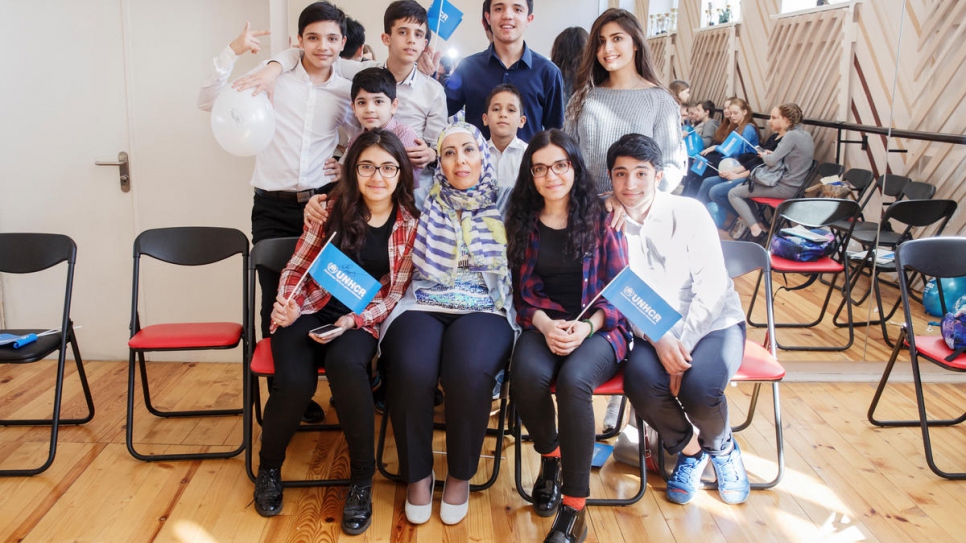 Afghan history and language teacher Nahid with local and refugee children at Evrika.