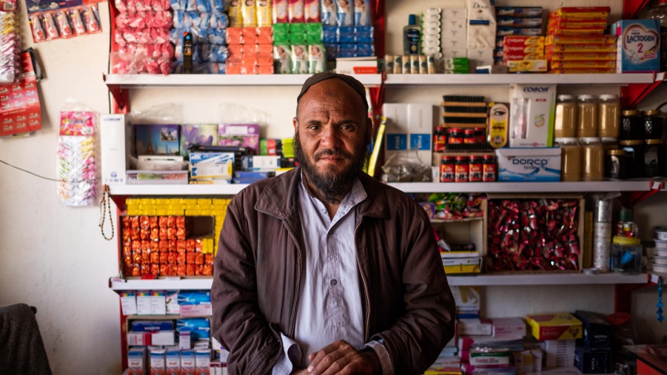 A returned Afghan refugee stands behind the counter at his shop in Dasht-e Tarakhil, Kabul, Afghanistan on November 18, 2018.
