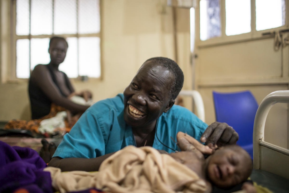 Dr Atar with a newborn baby in the maternity ward of Bunj Hospital. 