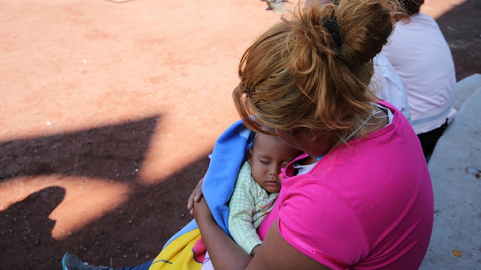 Mitzy holds her one-year-old son Luis at a temporary shelter in the Jesús Martínez "Palillo" stadium in Mexico City.