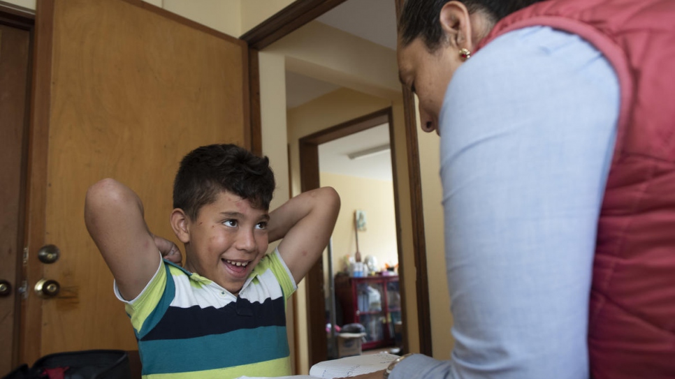 Director of the Hearts Without Borders childcare centre Sandra Rodriguéz gives individual instruction to 11-year-old Venezuelan boy Anderson Arenas.