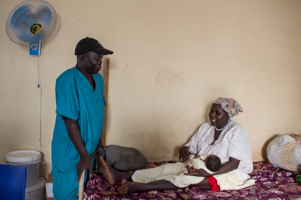 Dr. Evan Atar Adaha talks to a patient from Sudan, Gisma Al Amin, in the maternity ward of Bunj Hospital in Maban County, South Sudan. 