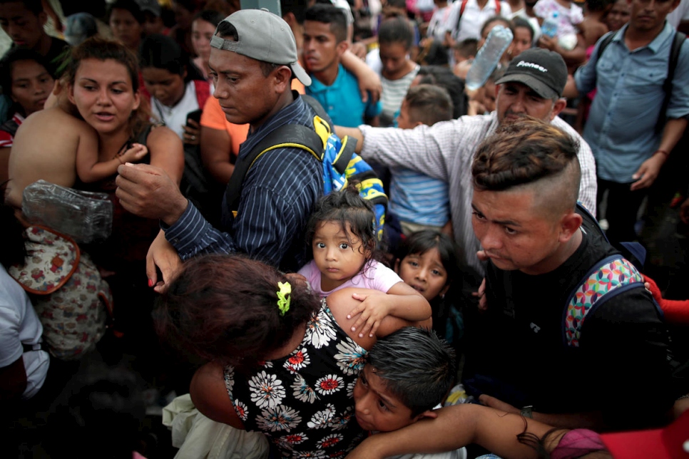 Children of Central American migrants wait with their parents to apply for asylum in Mexico at a checkpoint in Ciudad Hidalgo