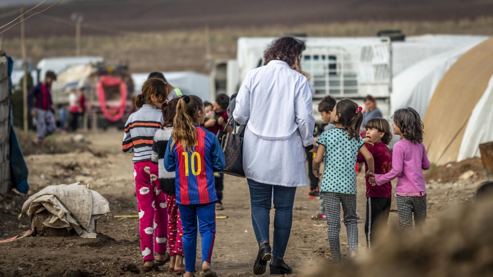 Nagham Nawzat Hasan visits an informal tented settlement for displaced people in Duhok Governorate in the Kurdistan region of northern Iraq..