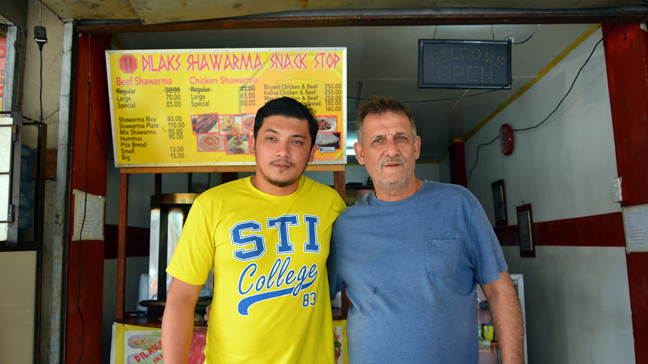 Maher, pictured here with son Khalid, manages their family’s shawarma restaurant in Las Piñas. Photo: © UNHCR/A. Gonzales
