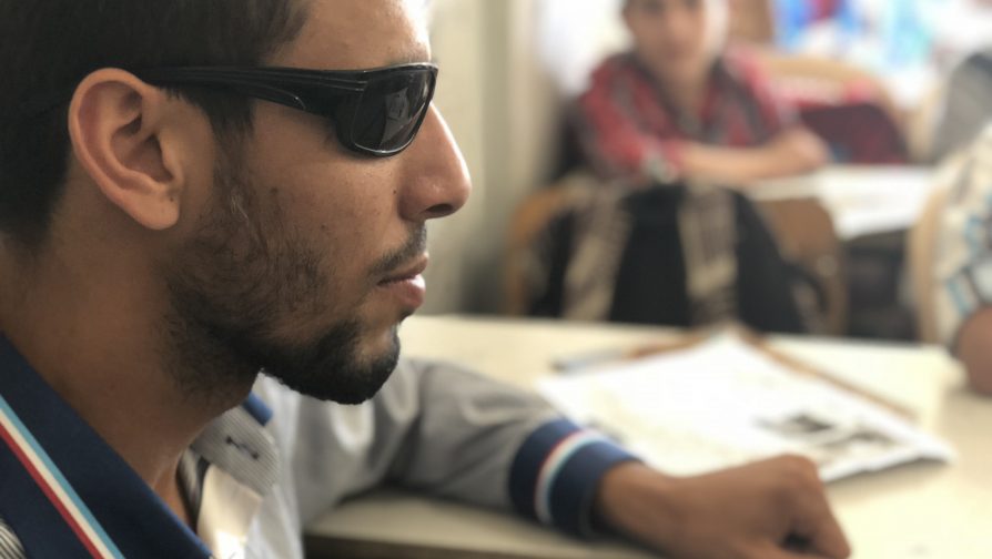 With resolve and a cell phone, blind refugee resumes school