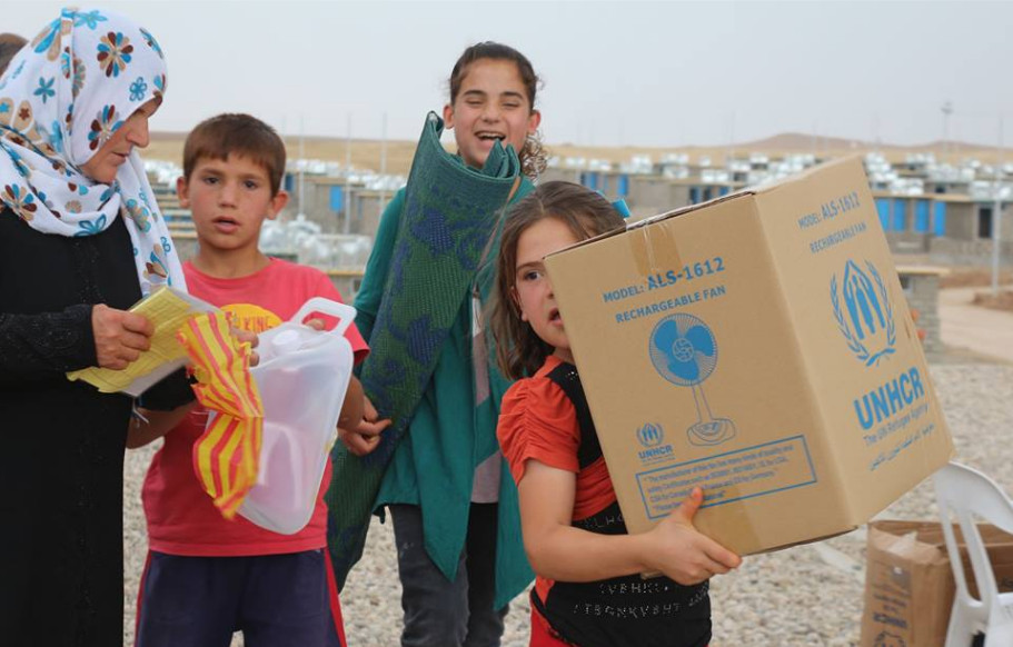 A Syrian refugee family in Domiz camp 2 in Duhok governorate receives special items for summer