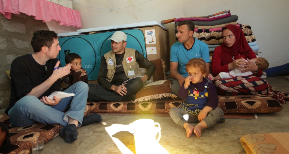 Michael and a member of a UNHCR partner organization interview a family who have benefited from UNHCR's legal assistance activities at a camp for internally displaced Iraqis in the Kurdistan Region of Iraq