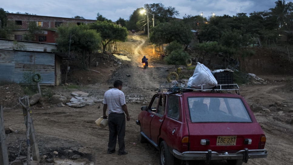 A car passes through Las Delicias neighborhood of Cúcuta, Colombia. Over 60% of its neighbours were displaced by the Colombian armed conflict.