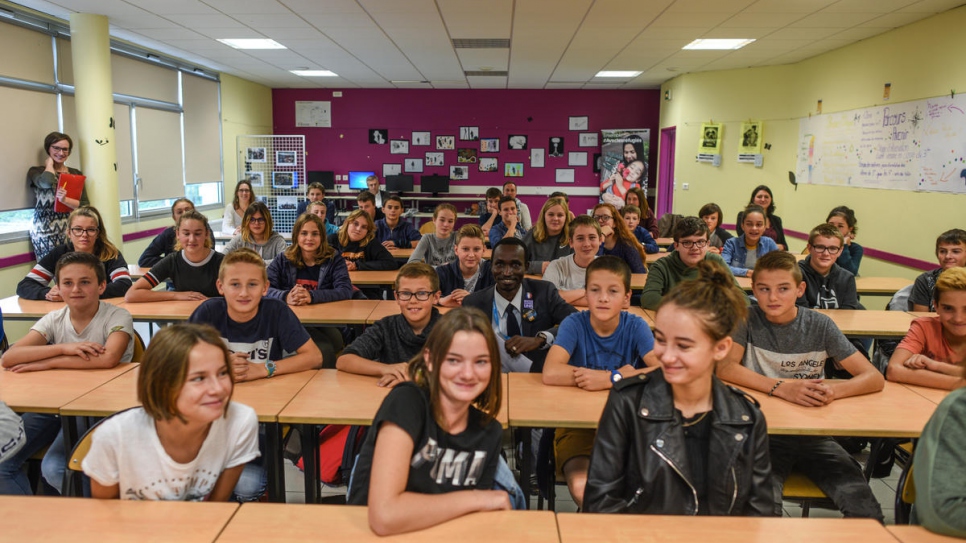 Hassan Mahamat (au centre), originaire du Soudan, avec des élèves du Collège Octave Mirbeau à Trévières. Il leur a raconté son trajet via la Libye, puis la mer Méditerranée. 