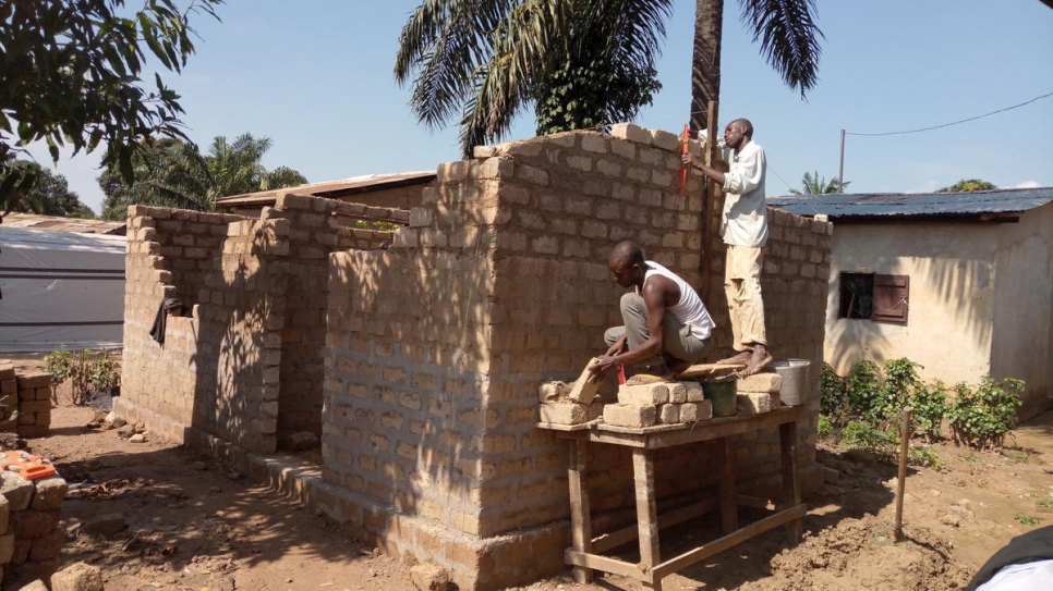 رجلان يبنيان منزلاً كجزء من مشروع البناء الخاص بالمفوضية في مقاطعة ماليماكا في بانغي، جمهورية إفريقيا الوسطى، نوفمبر 2017.