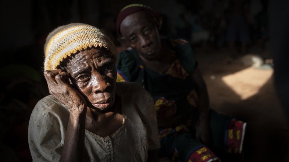 An elderly woman sits in a hall where Anglophone refugees from Cameroon wait to be relocated at the Agadom Refugee Settlement in Ogoja, Nigeria.