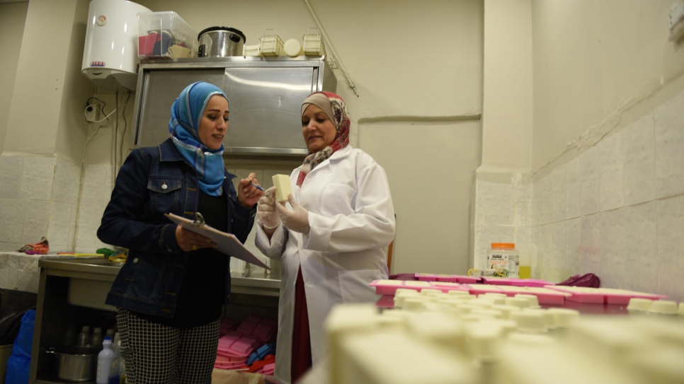 Jordanian employee Susan (left) helps Najwa to inspect the products before packaging.