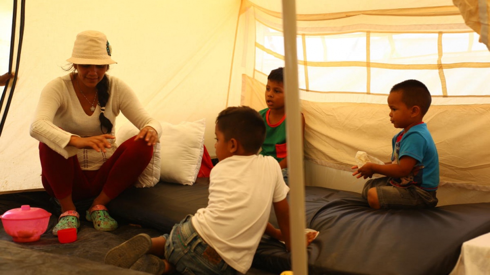 Venezuelan asylum-seeker Darlys and her children inside their tent at the newly-established Integrated Assistance Centre in Maicao, Colombia.