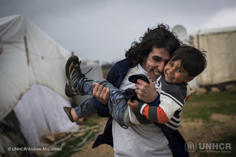 Hani and his brother Ashraf horse around outside their shelter in Lebanon's Bekaa Valley in March 2014.