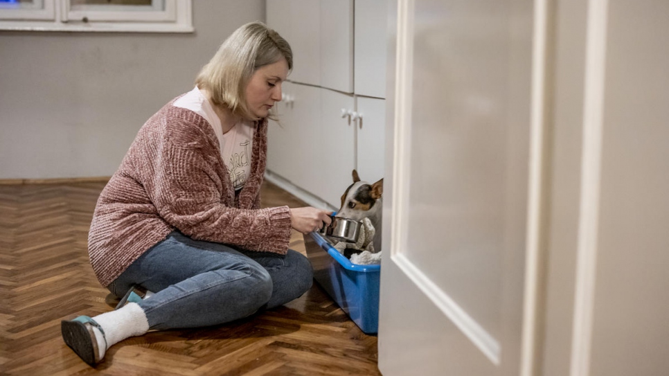 Ida gives her dog Lulu some water. Her husband, Mawaheb, is a refugee from Syria who works as a software engineer for an energy company.