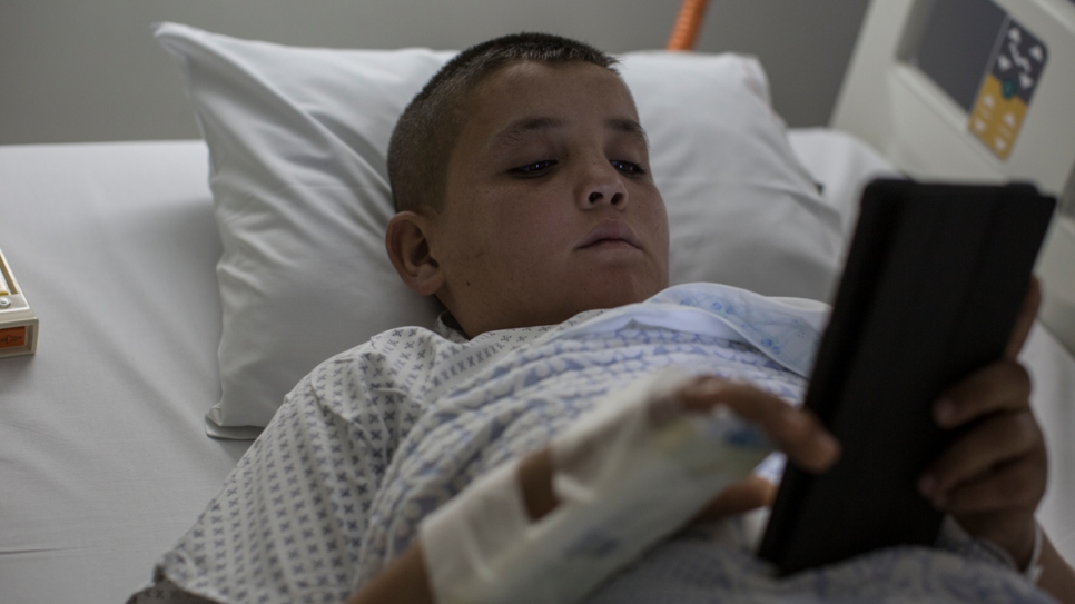 Mohamed rests after having an intravenous drip inserted, at the Sacre Coeur Hospital.