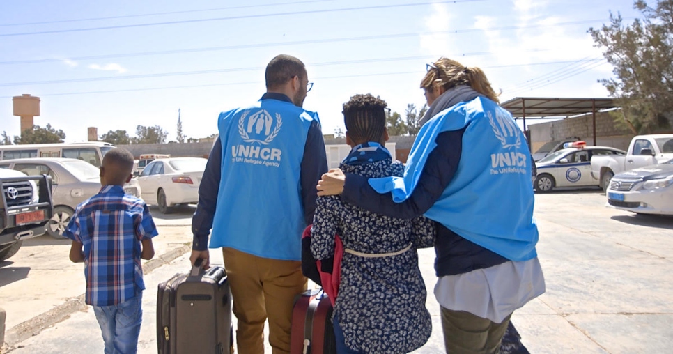 Libya. UNHCR staff members accompany 2 Eritrean kids out of a Libyan detention center