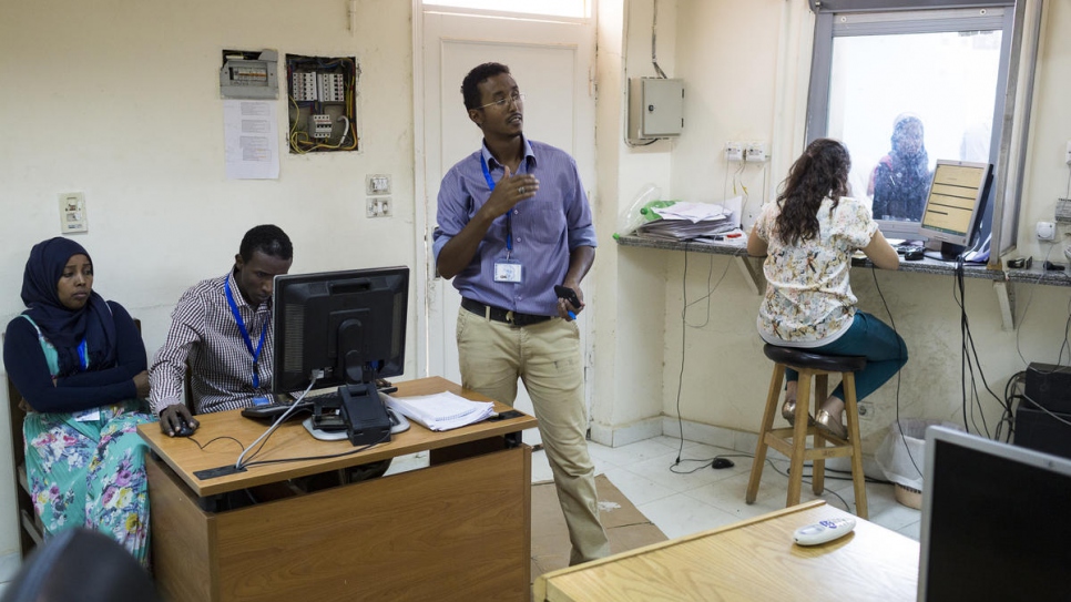 Guled (centre) coordinates the schedules of his fellow interpreters according to the needs of the UNHCR office in Cairo.