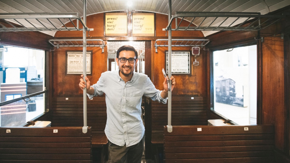 Afghan asylum-seeker Omid, 31, rides an old train at the Vienna Technical Museum.