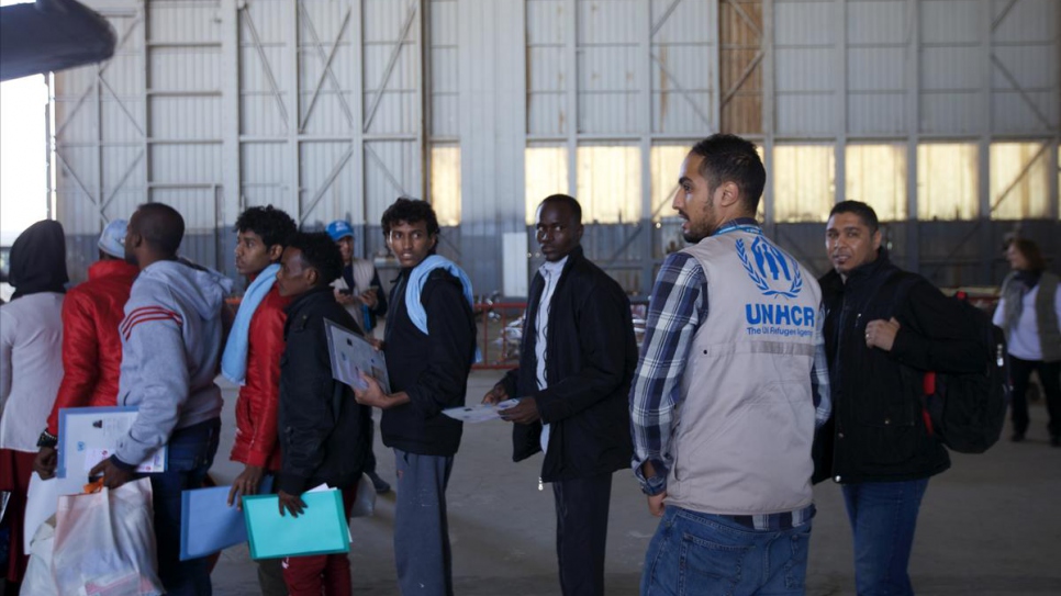 A UNHCR worker supervises the evacuation process at Tripoli airport.