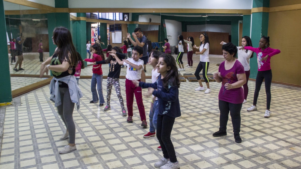 Adrianna - third from right, in purple - takes a dance class in Ecuador where she is among Venezuelans seeking safety.