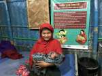Rohingya refugee Rajuma cradles her newborn daughter at a 24-hour prim...