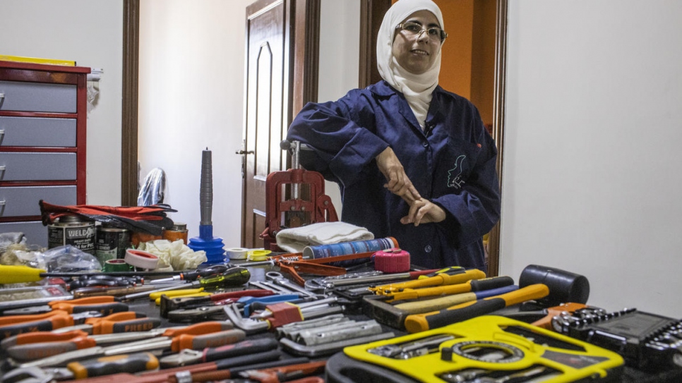 Safaa stands in her training academy in Irbid, Jordan, where she teaches plumbing.
