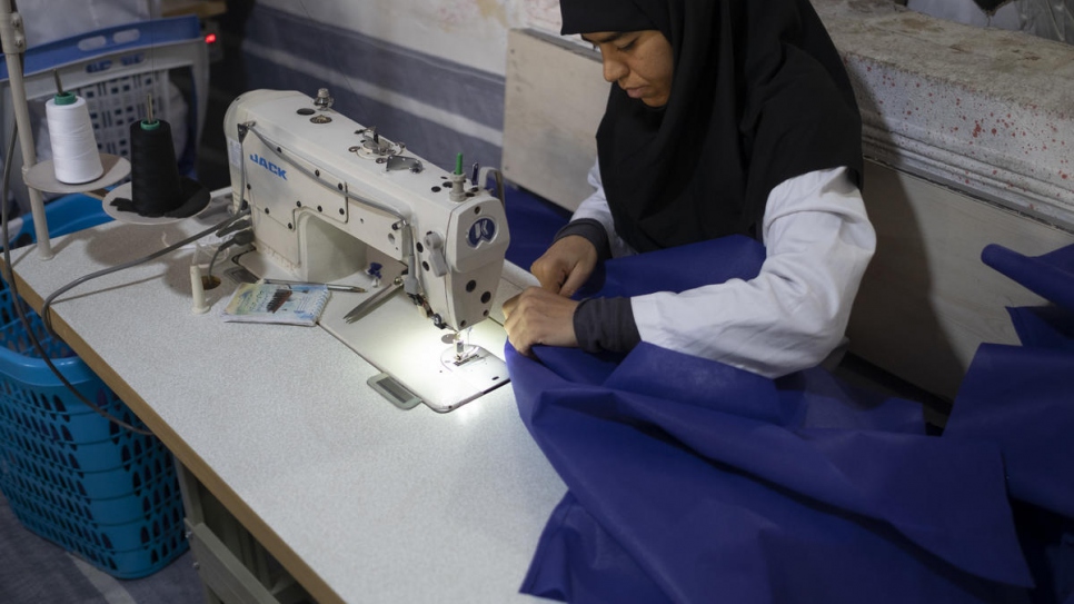 Iranian employee Fatemeh, 36, at the tailoring workshop.