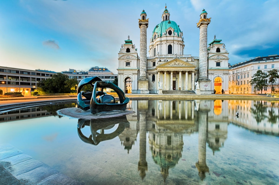 St. Charles's Church.  in Vienna, Austria at sunrise. Vienna is one of a growing number of cities around the world that are choosing to empower refugees.  